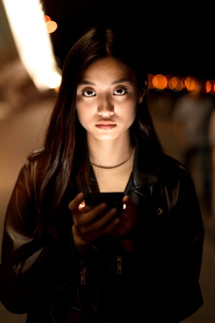 woman using smartphone at night